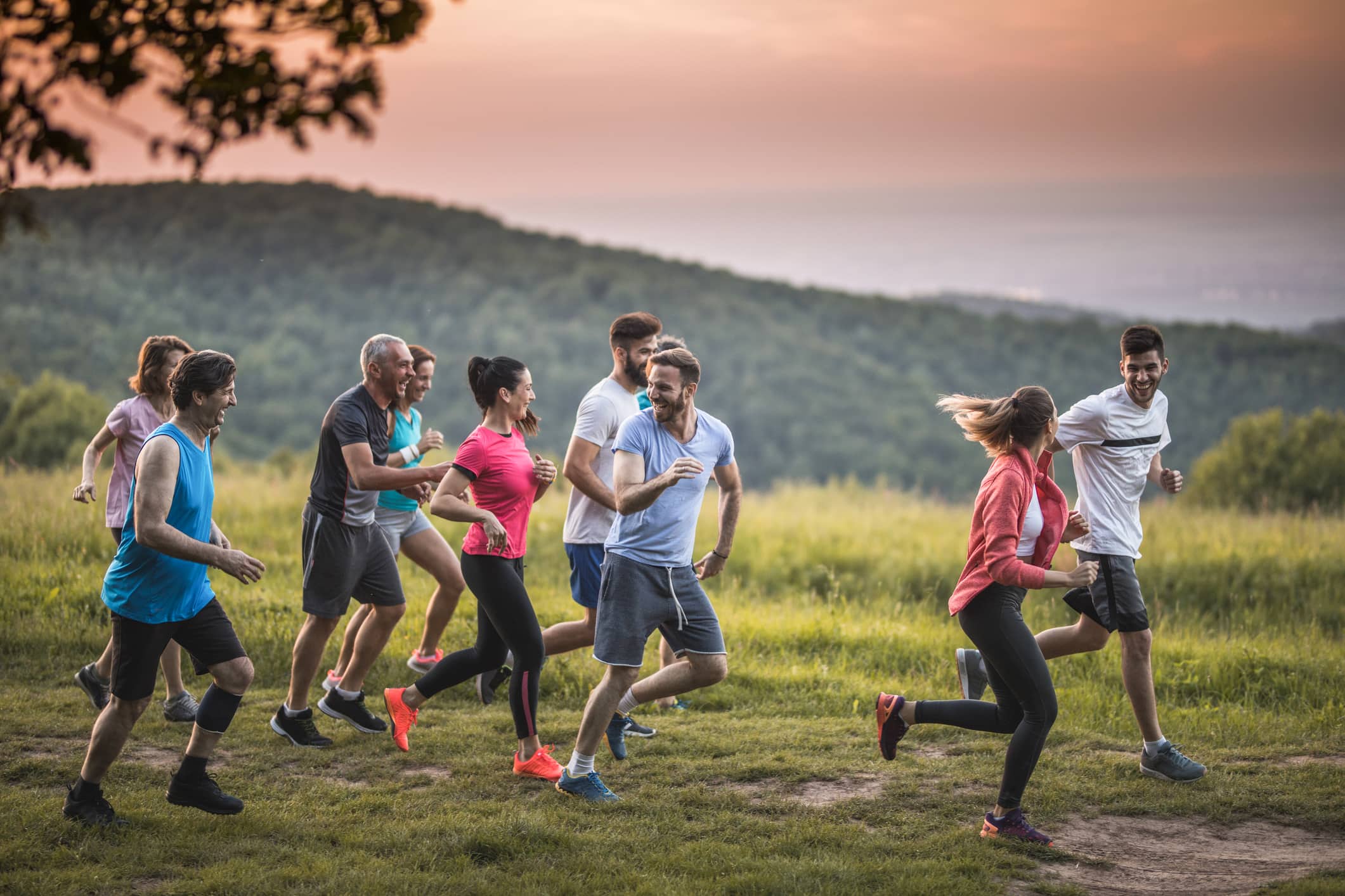 Group of runners moving together outdoors to support the section about running with others