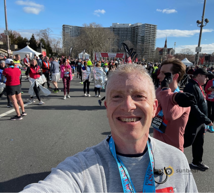 Runner selfie at a race finish to illustrate the payoff of focused training and race-day mindset