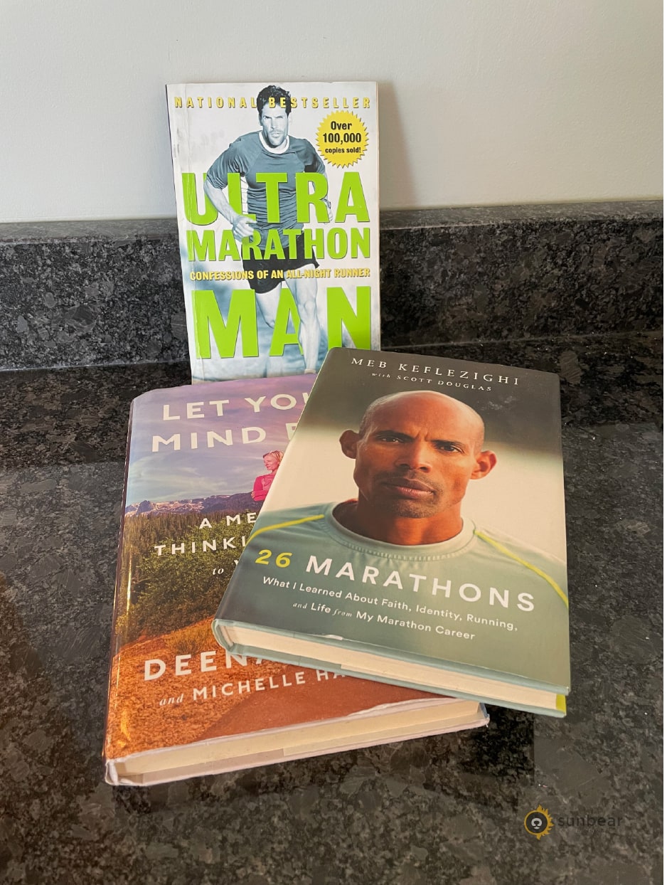 Stack of recommended running books that matches the motivation reading list in this section