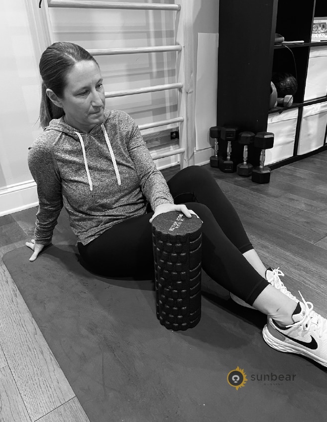 Runner using a foam roller to support the recovery and self-assessment advice in this section
